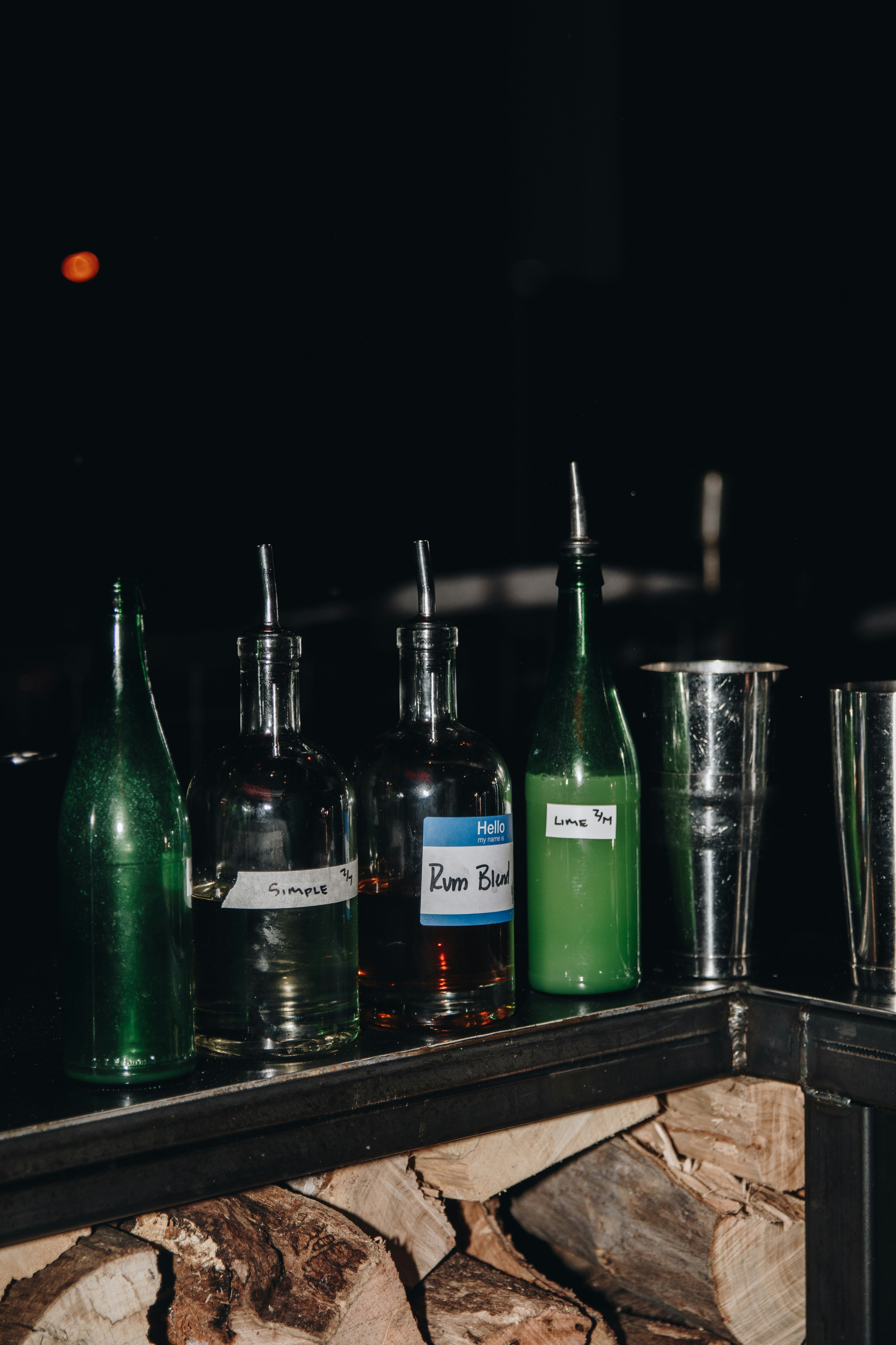 green glass bottles on brown wooden table